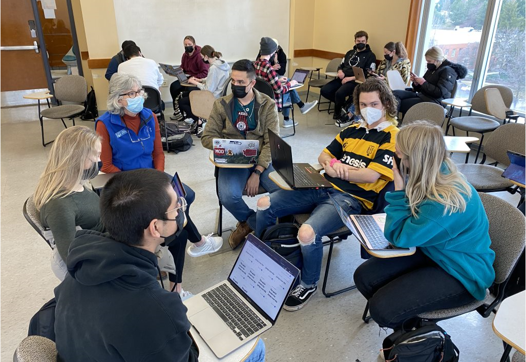 Vicki Leeper from Disability Action Center Northwest visits with the teams in COMSOC 326 for updates about the 5k for Mental Health event.